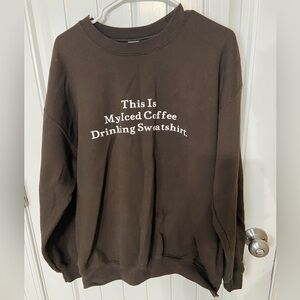 Brown sweatshirt with white wording